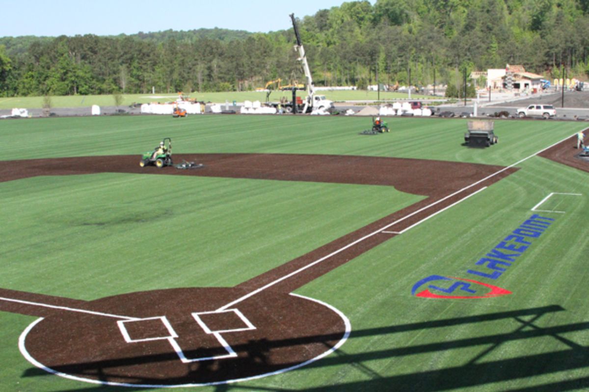 A baseball field featuring a vast green expanse and a well-defined baseball